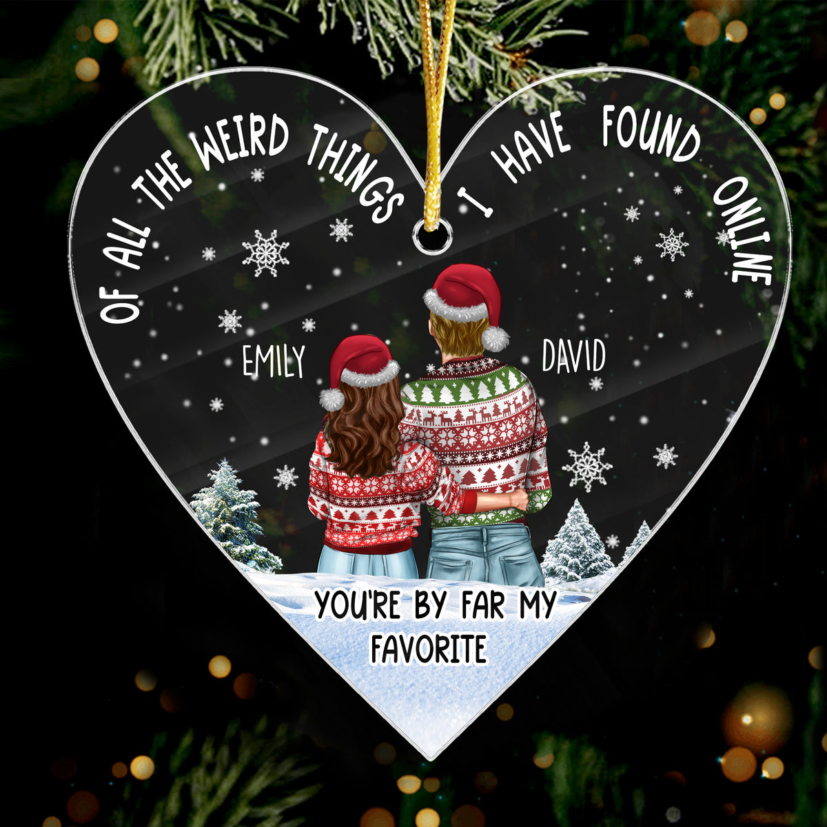 Couple 1st Christmas ornament made of clear acrylic in a heart shape, hanging on a pine tree branch with sparkling holiday