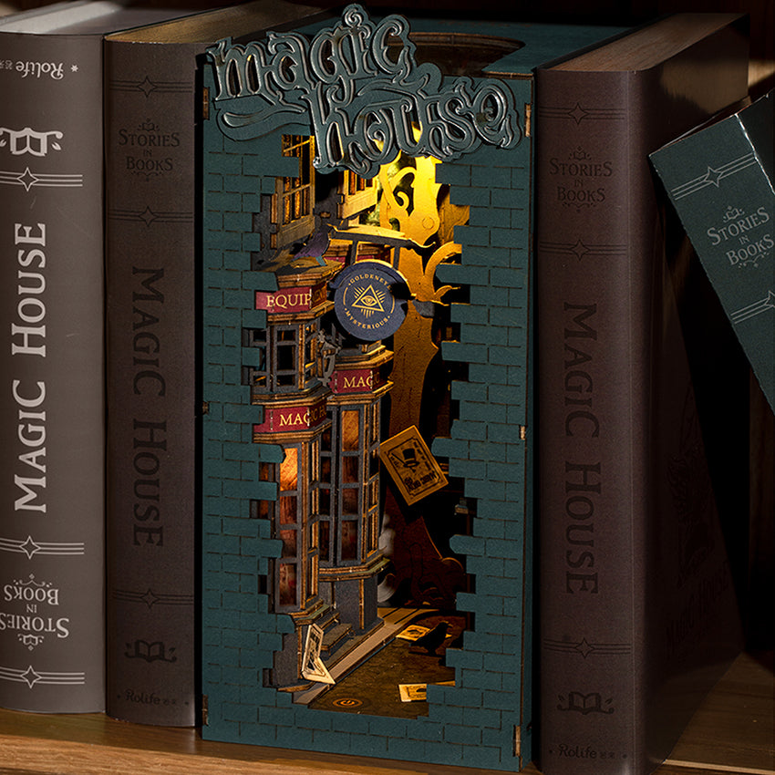 Magical alley shelf insert book nook placed between two dark books on a wooden bookshelf.