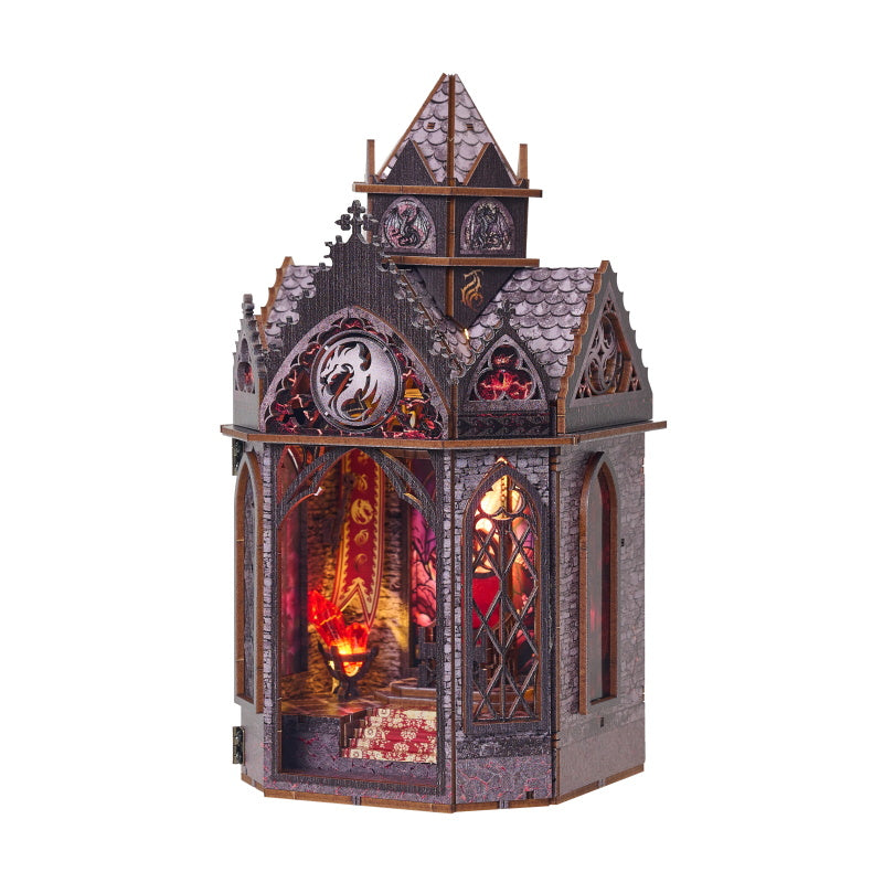 Assembled DIY wooden puzzle book nook with gothic stone spire design, glowing amber interior, and arched windows