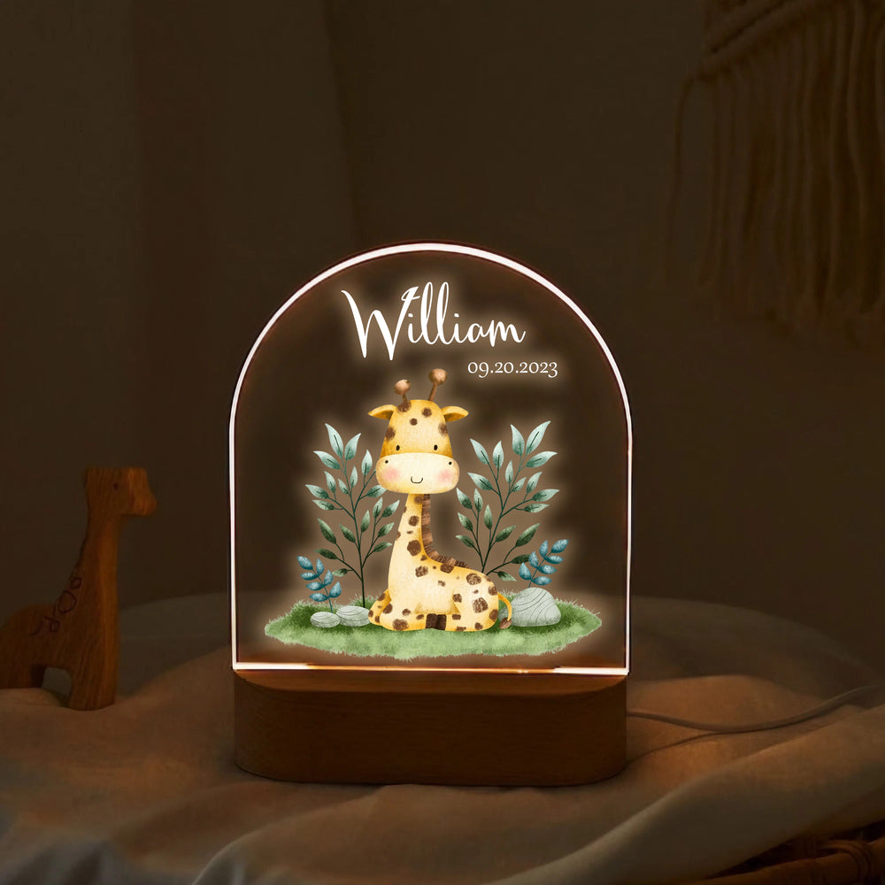 Personalized printed night lamp on a cozy textured surface featuring an illuminated watercolor giraffe and foliage design.