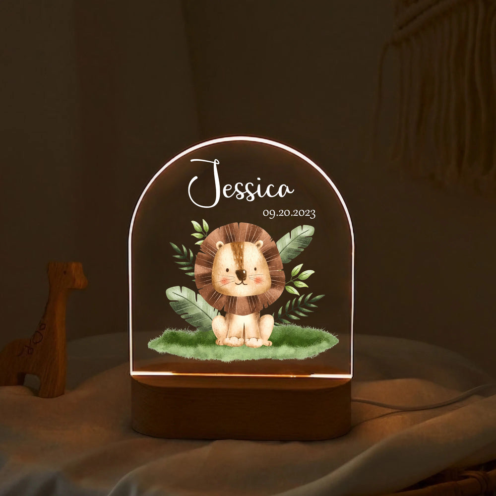 Personalized arch night lamp glowing warmly with a cute safari lion graphic, custom text, and oval wooden base on a soft