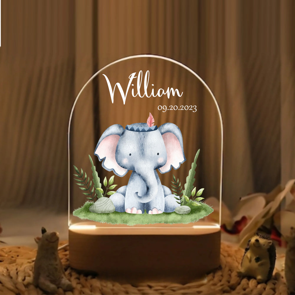 Personalized portrait light featuring a warm white glowing arched acrylic panel with baby elephant graphic, name William, and