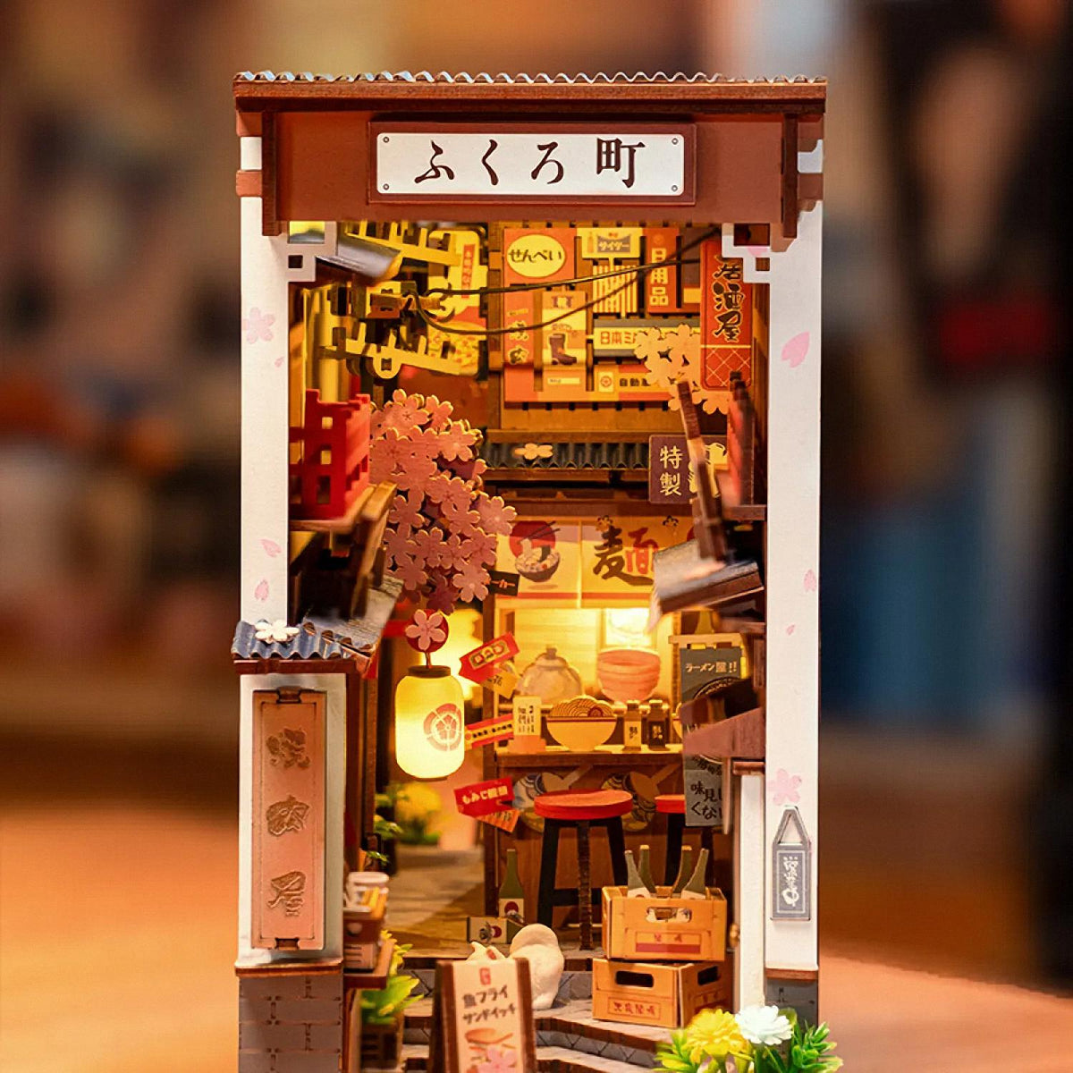 Detailed model of a Japanese store with various items and signs.