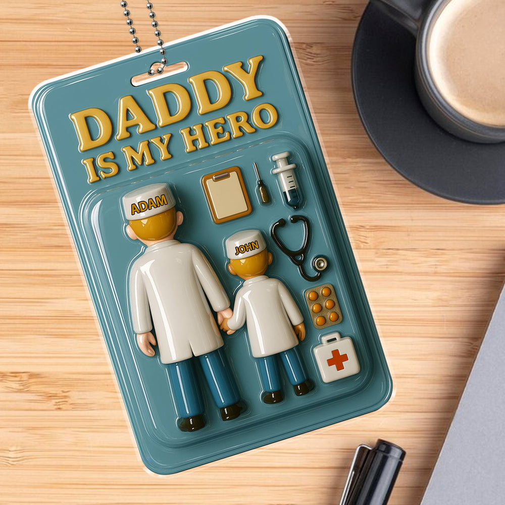 Personalized doctor dad and son car hanging ornament on a wooden desk with coffee, featuring toy figures in medical scrubs.
