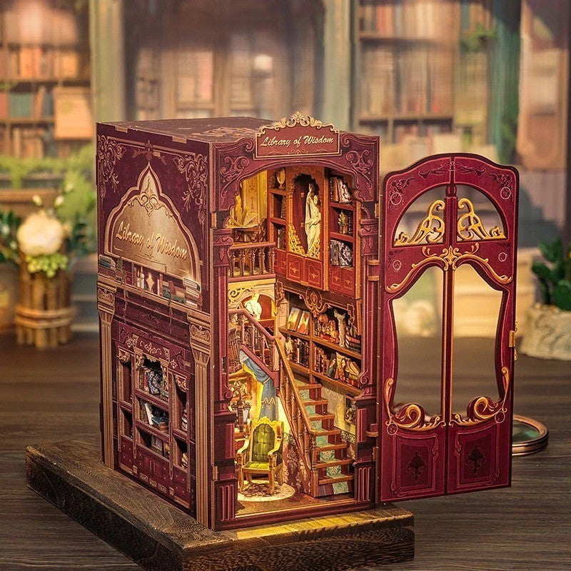 Side view of the open wooden book nook with a miniature library, staircase, and warm LED lighting.