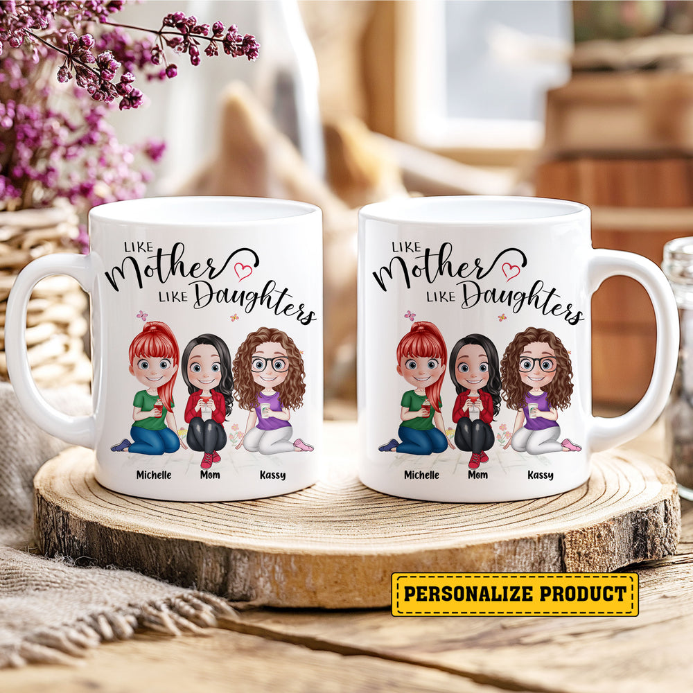 Two personalized ceramic mugs displaying mother and daughters custom artwork sitting side-by-side on a rustic wooden slice.