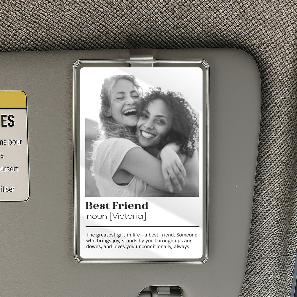 Personalized best friend car visor clip attached to a gray vehicle sun visor with a custom black-and-white photo and