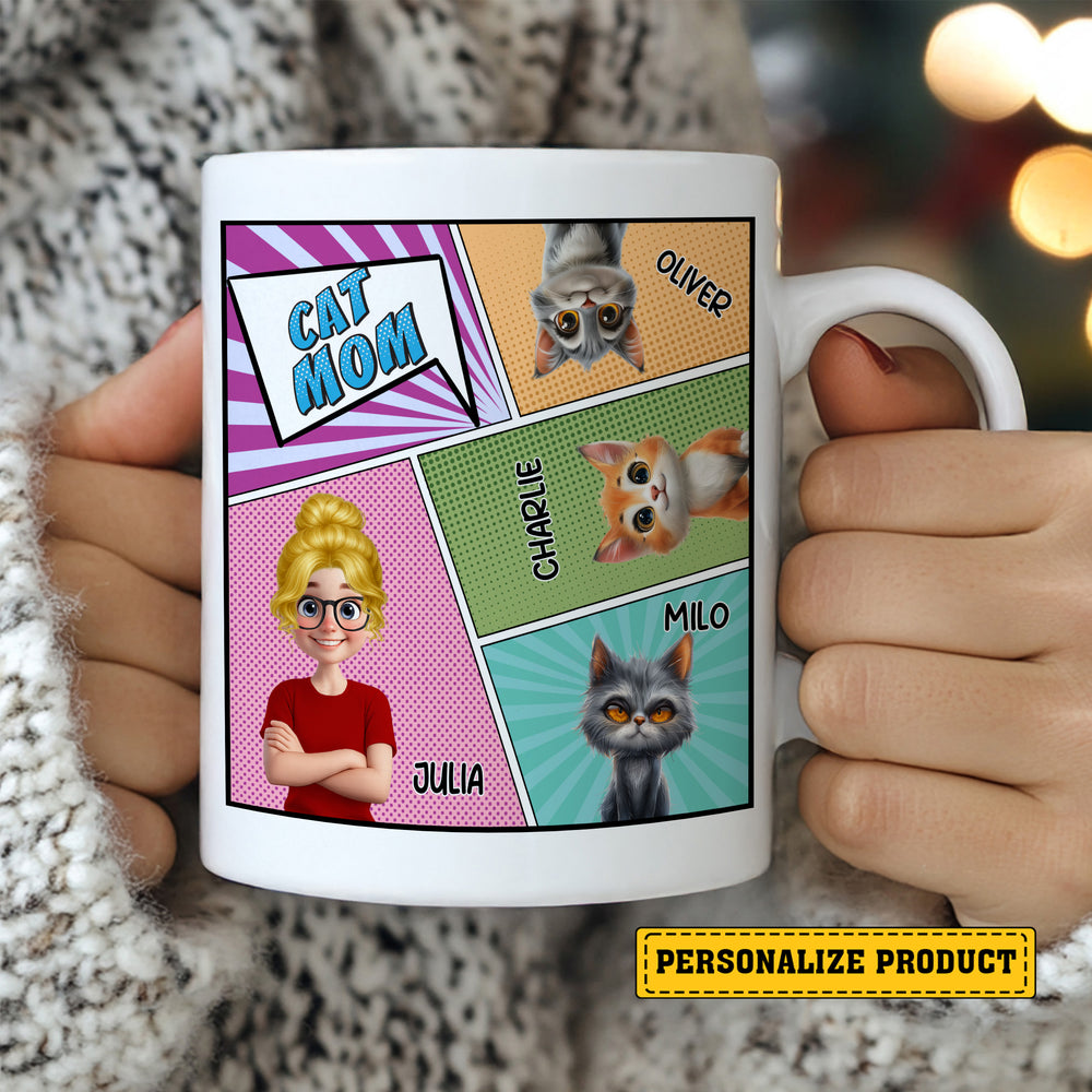 Person holding a white comic book style cat mom ceramic mug featuring a custom blonde avatar and three cat portraits with