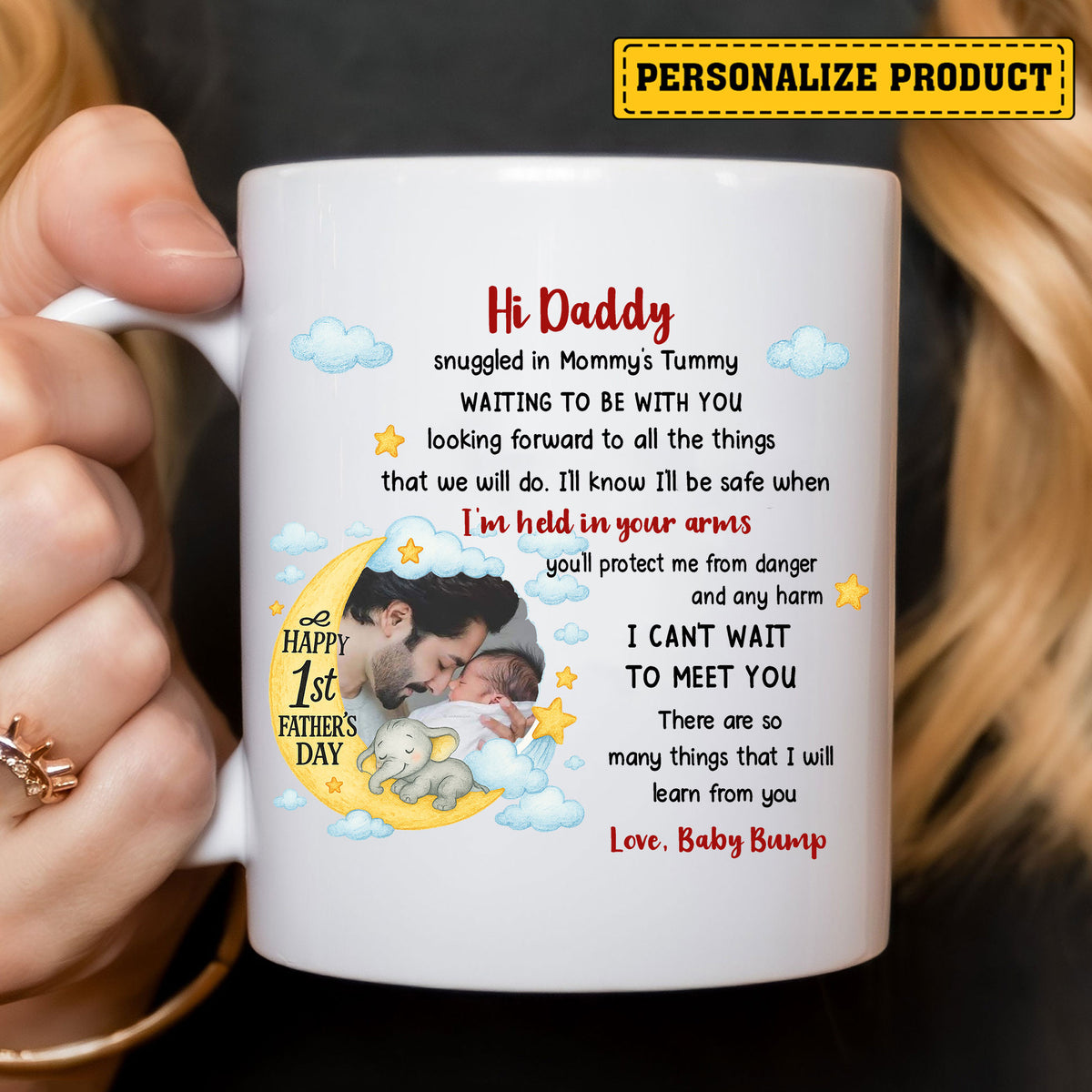 Close-up of white custom mug held by woman, showing personalized baby photo frame, blue clouds, stars, and First Father's Day