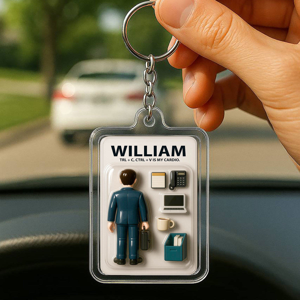 Personalized acrylic keychain featuring a 3D-style action figure blister pack graphic with a suited office worker and desk