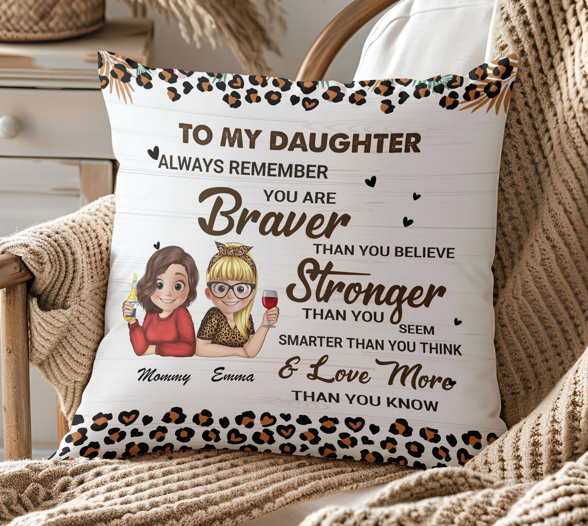 Personalized daughter pillow resting on a cozy cream knit blanket on an armchair, showcasing the inspirational braver than