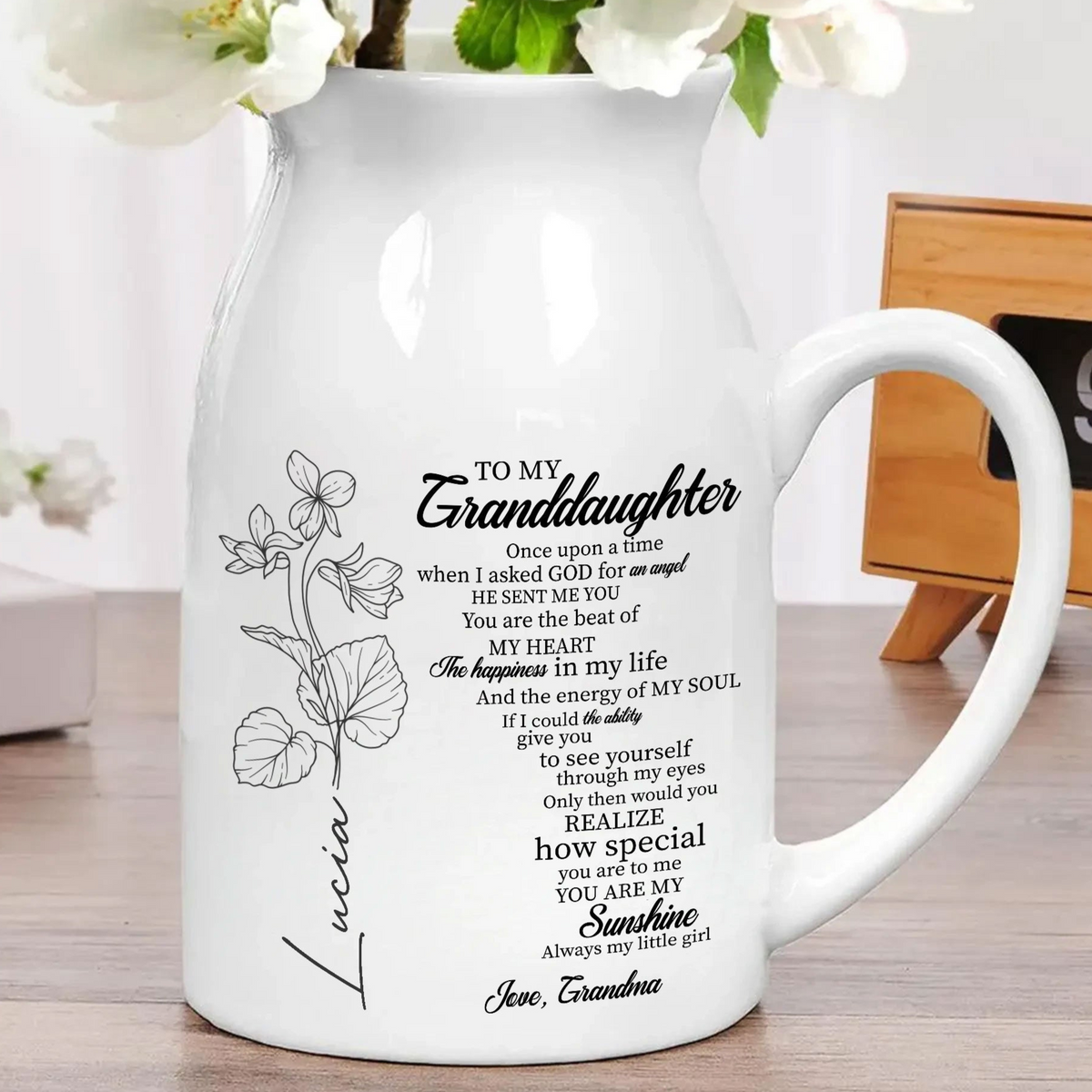 White ceramic pitcher-shaped flower vase with side handle, featuring a black birth month flower illustration, name, and