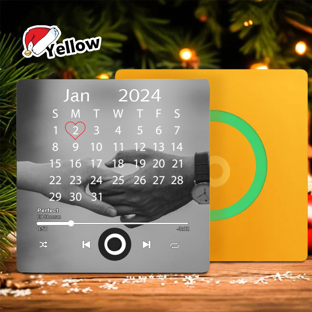 Yellow square fridge magnet with a calendar date marked with a heart, a couple's photo, and digital music player buttons.