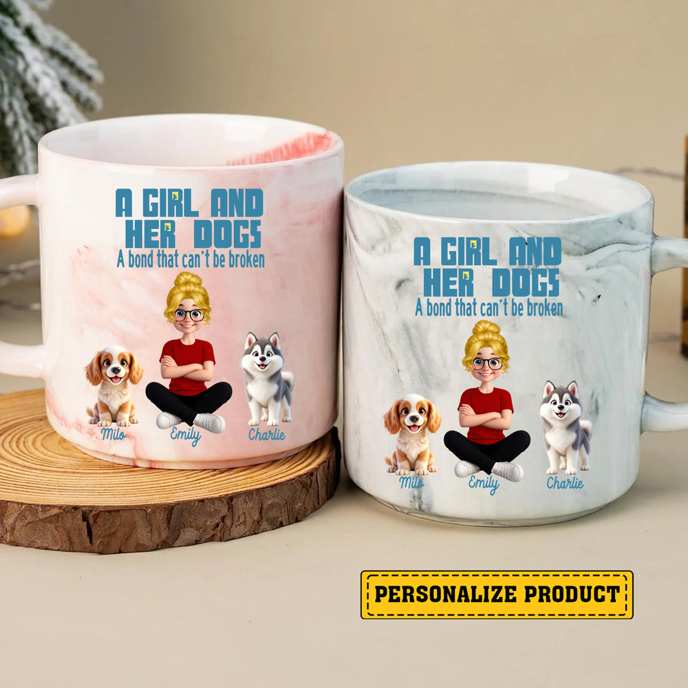 Two custom marble mugs in pink and white displaying a girl and her dogs graphic next to each other