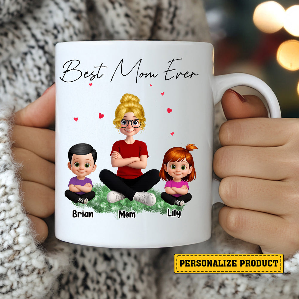 Close-up of hands holding the personalized white ceramic mug featuring animated mother and children characters.