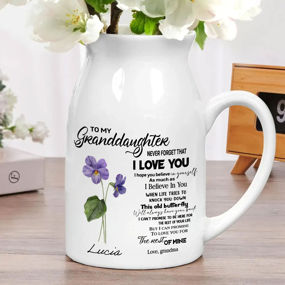 Custom birth month flower vase styled on a wooden tabletop with white flowers and a decorative clock in the background.