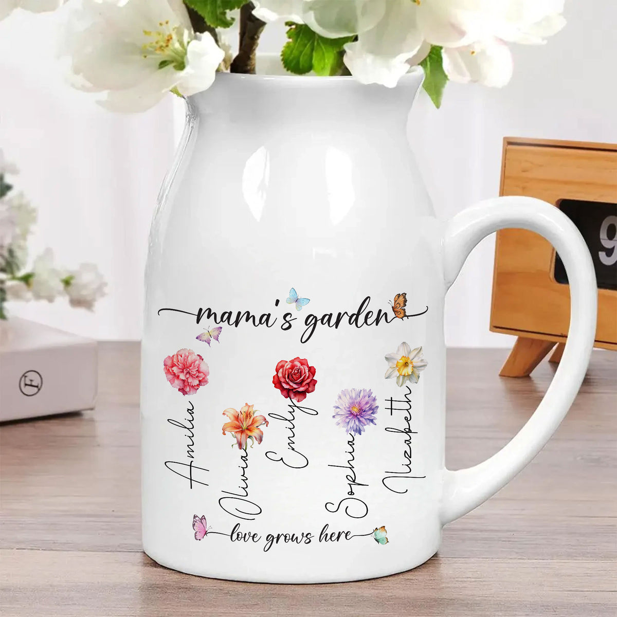 Personalized white ceramic flower vase filled with white blossoms, sitting on a wooden table with home decor.
