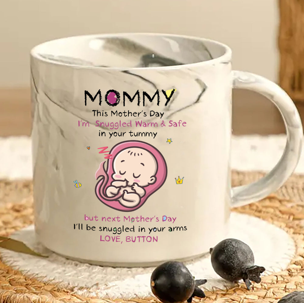 A white marble ceramic custom mug featuring a baby ultrasound illustration and first Mother's Day message.